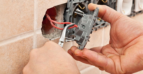 hands servicing electrical wires
