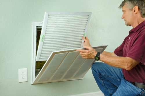 a man changing an air filter