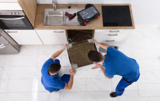men replacing a washer
