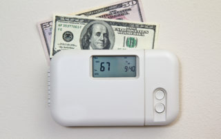 money tucked behing a thermostat