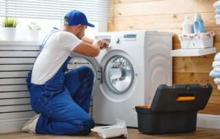 a man servicing a washing machine