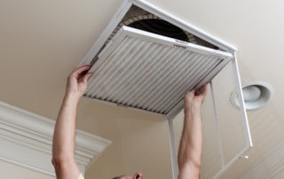 a man replacing an air filter