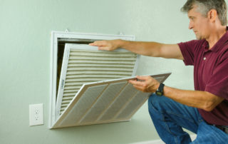 a man inspecting an air filter