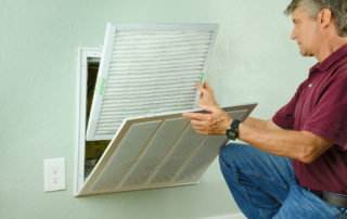 a man placing an air filter