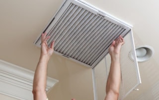 a man placing an air filter