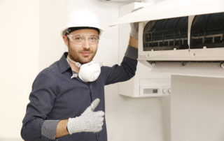 a man giving a thumbs up by an hvac unit