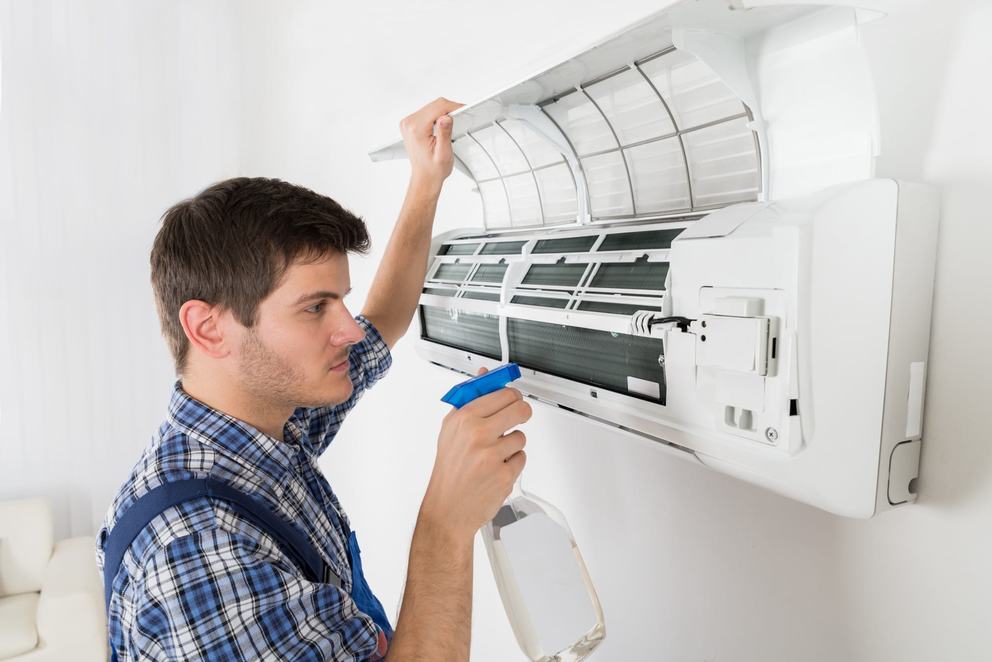 a man spraying an hvac unit