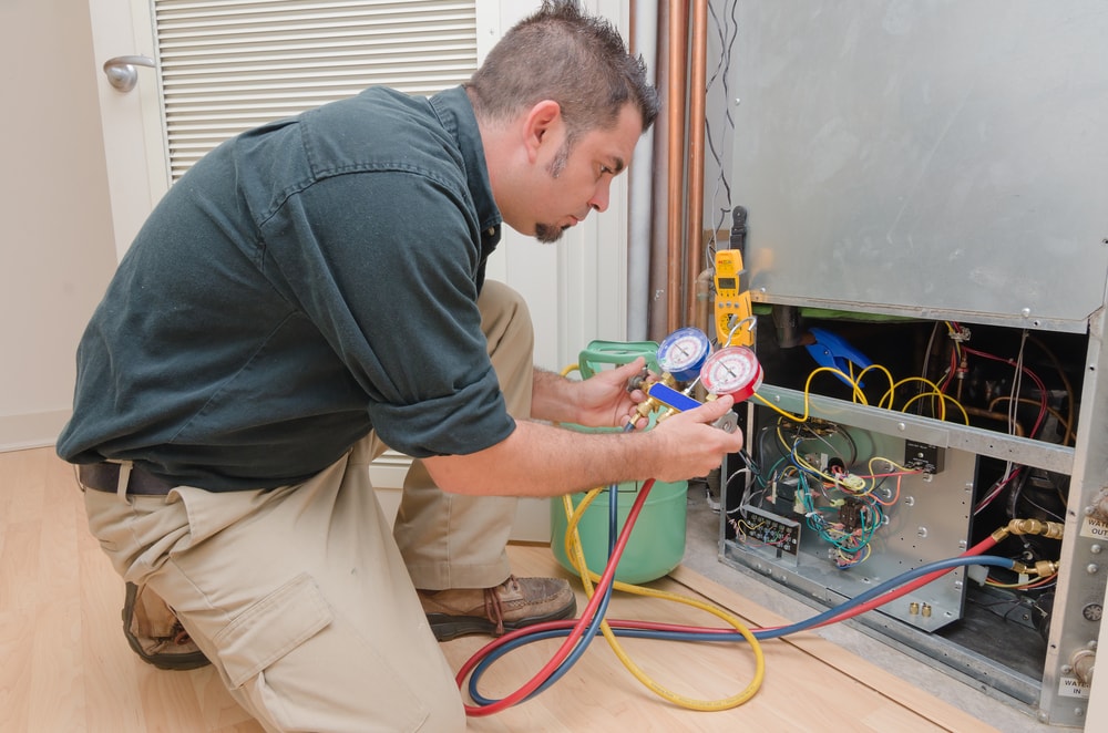 a man servicing an hvac unit