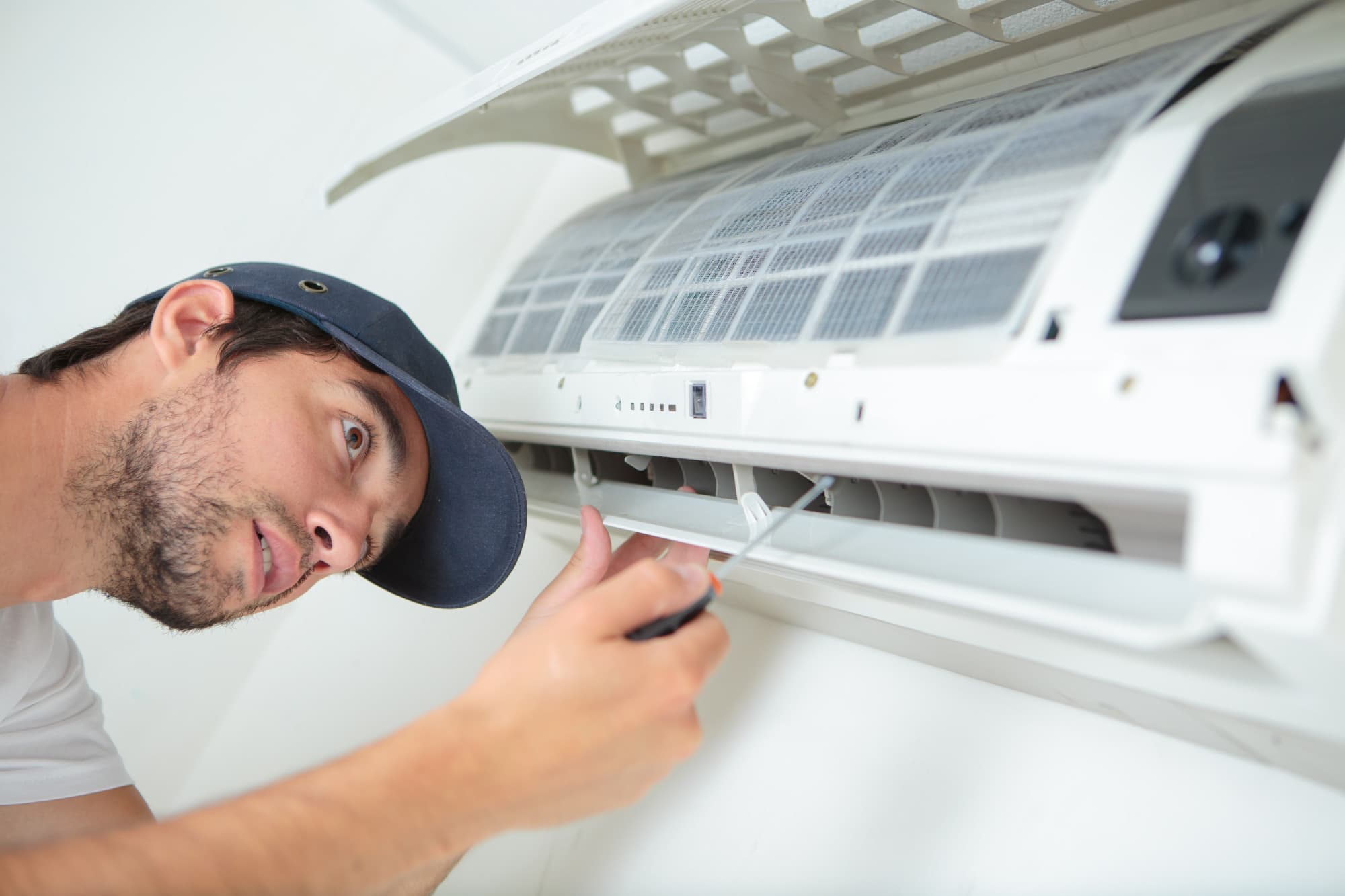 a man servicing an hvac unit