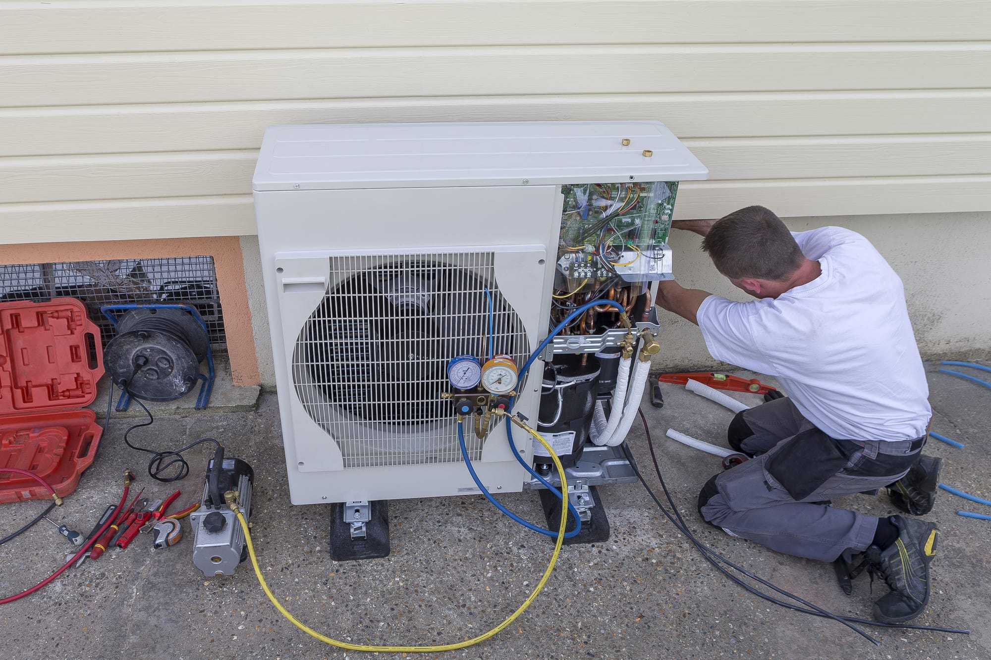 a man servicing an hvac unit