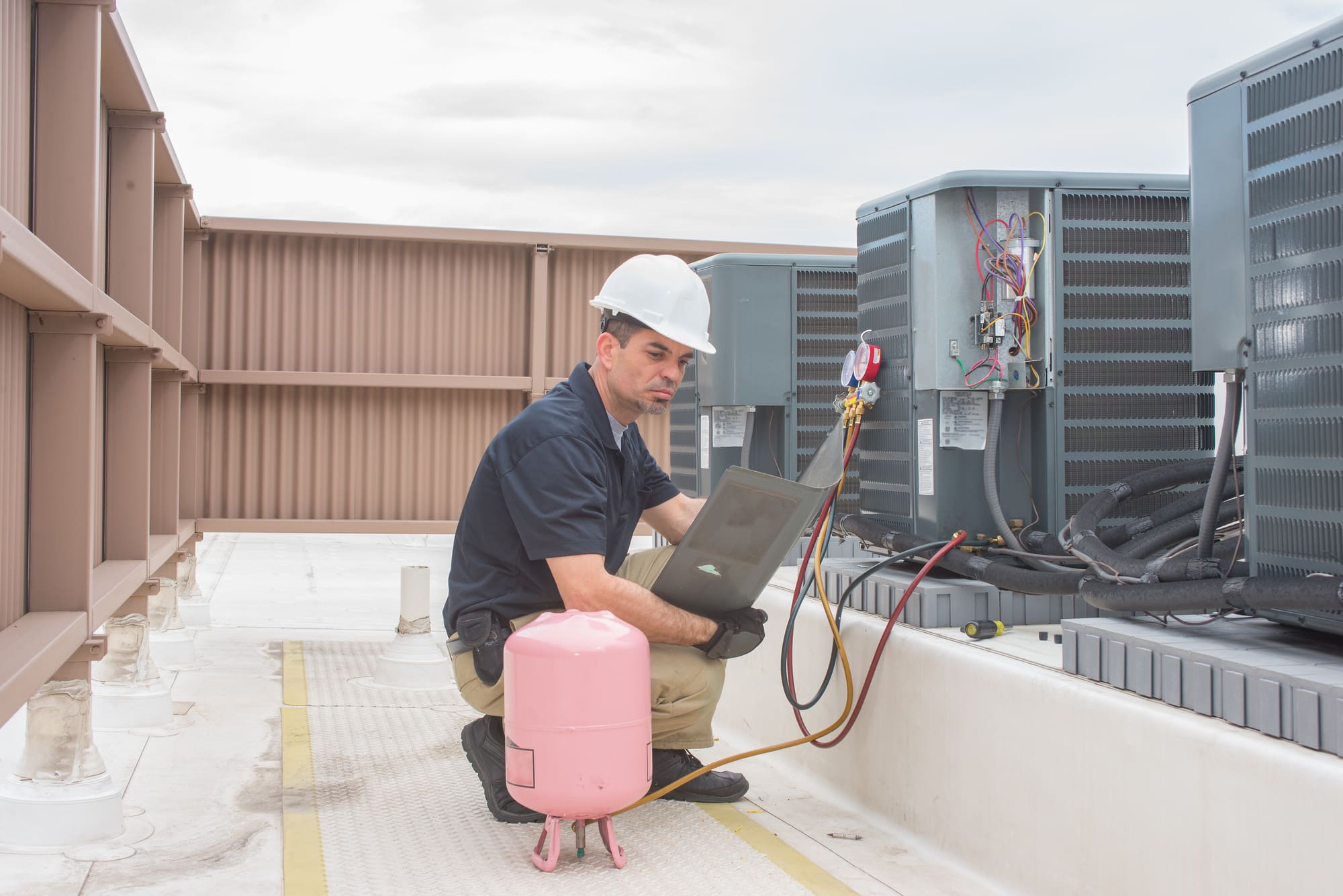 a man servicing hvac units