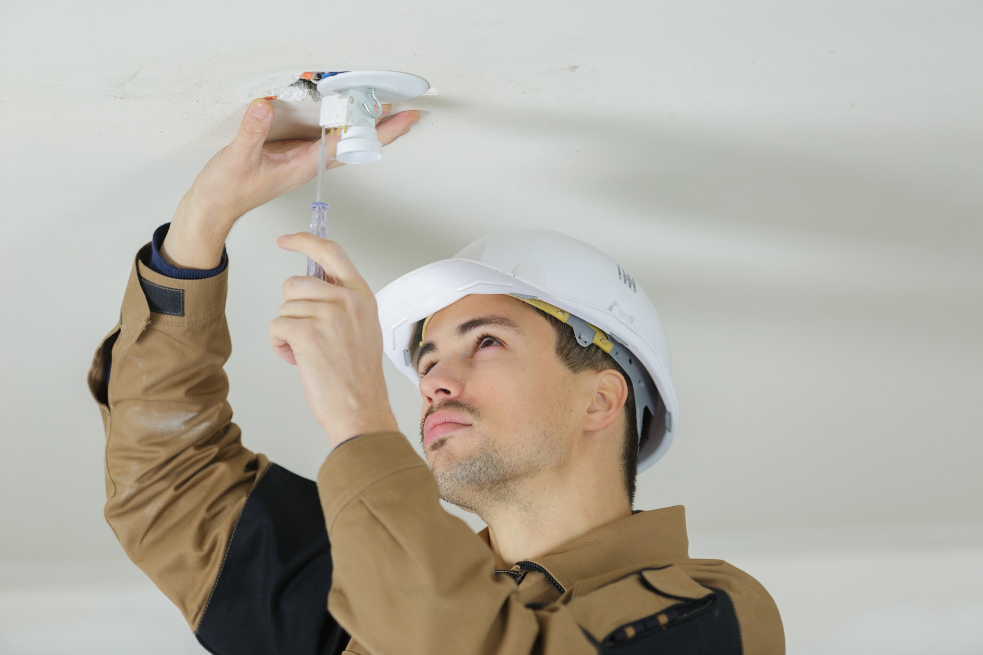 a man changing a light fixture