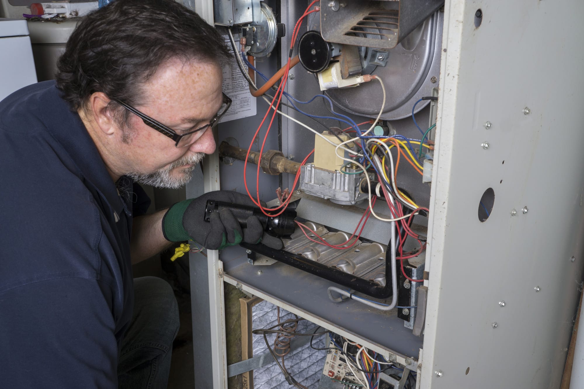 a man servicing a furnace