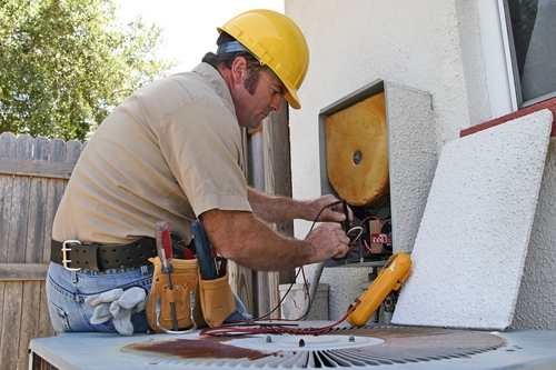 a man servicing an hvac unit